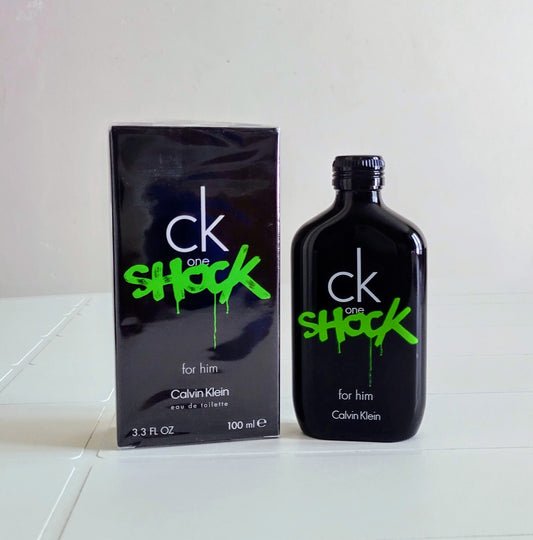Calvin Klein CK One Shock perfume bottle and packaging on a white surface