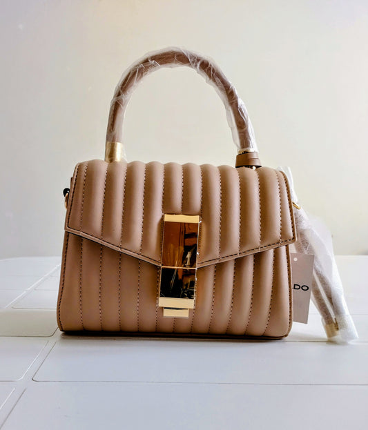 Beige handbag with gold accents on a white surface