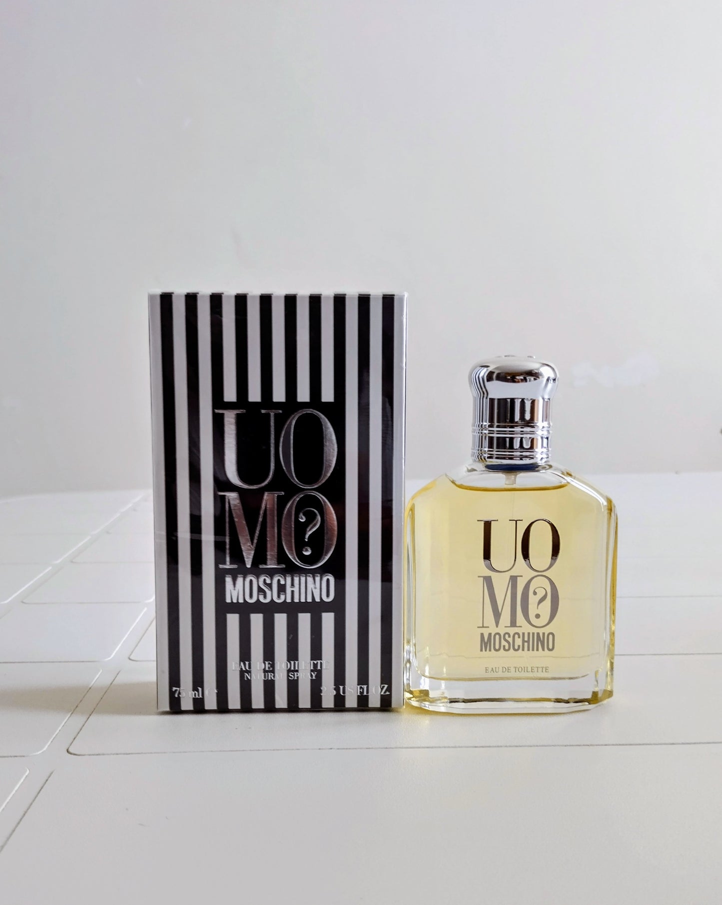 Moschino Uomo perfume bottle and packaging on a white background